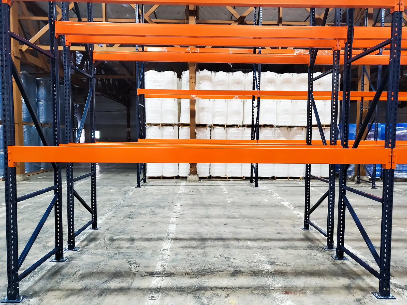 Orange teardrop pallet rack beams on navy uprights