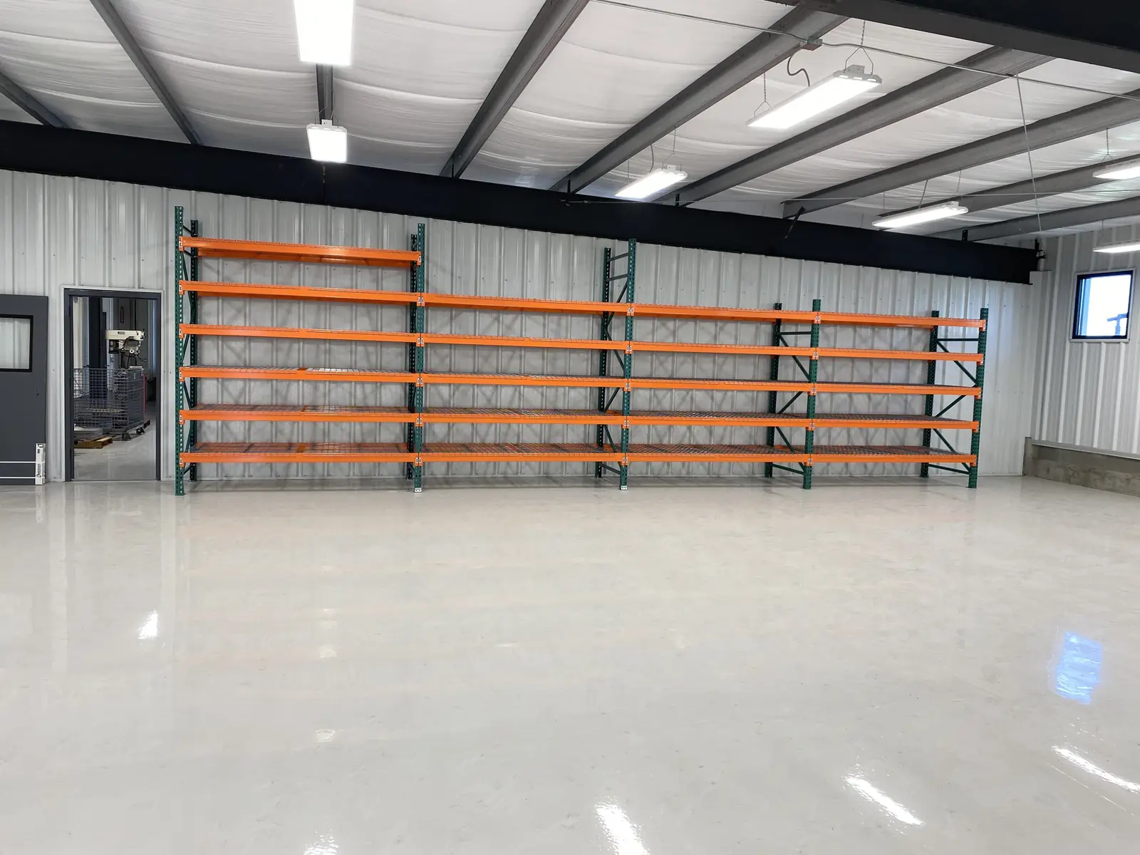 Freshly installed pallet racks along a warehouse wall