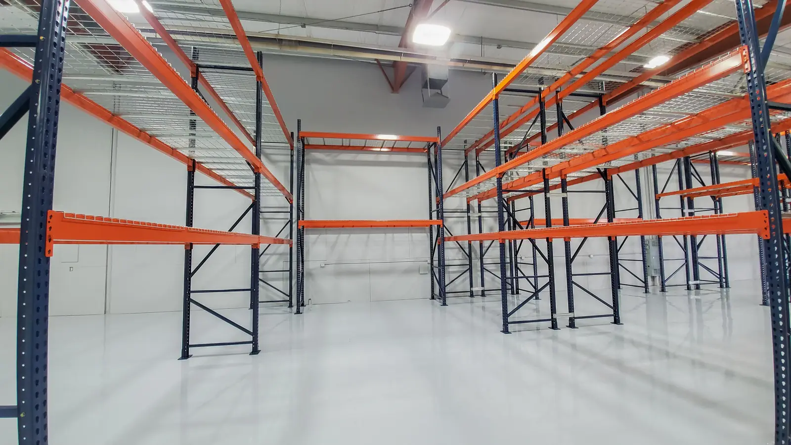 Rows of navy teardrop pallet rack uprights