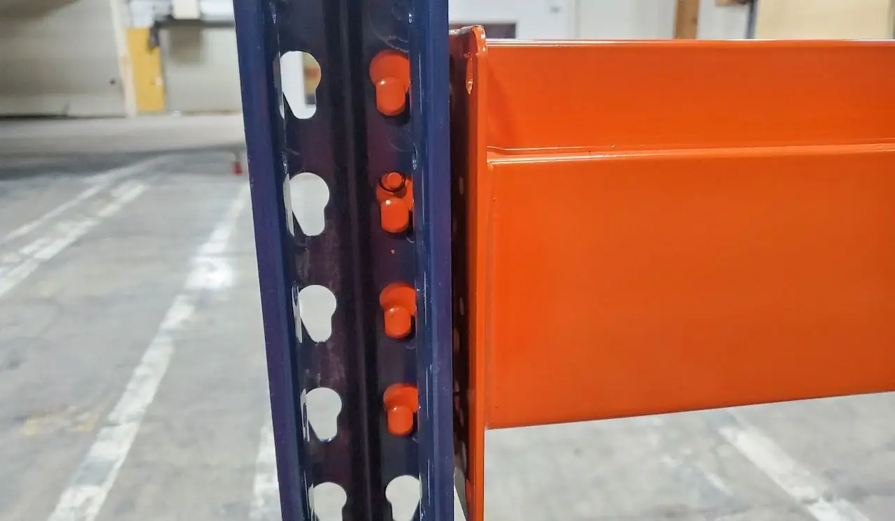 Close-up of a teardrop beam connector locked into an upright