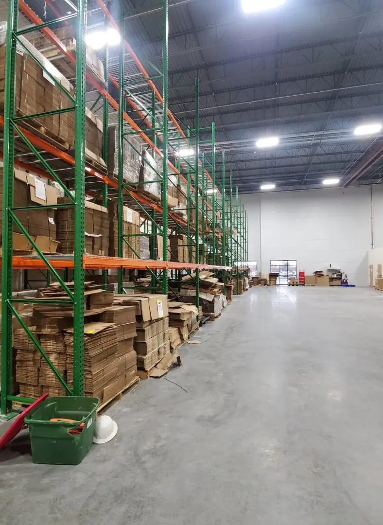 Green upright pallet racks with wire deck shelving